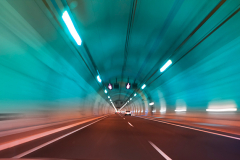 modern long tunnel on a highway with blue and red light